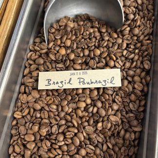 A close-up view of the Brazil Paubrazil roasted coffee beans showing their shape, size, and uniformity of medium roast degree.